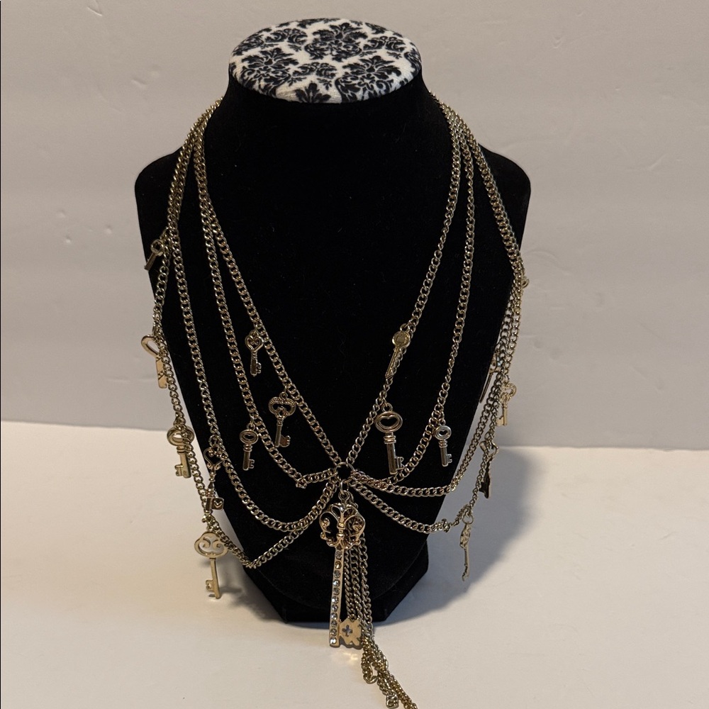 48.  Elegant Gold Key Charm Necklace.